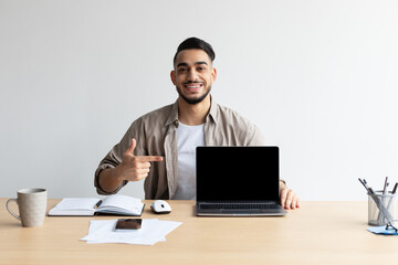 Happy Arab Guy Showing Laptop With Black Empty Screen, Mockup