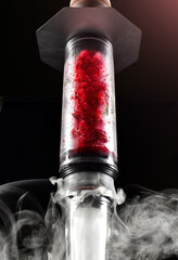 hookah with ice and smoke on black background
