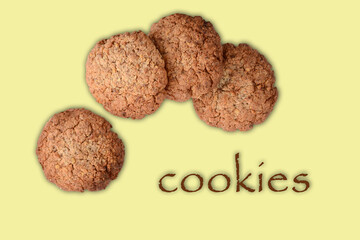 oatmeal cookies with nuts on a delicate yellow background. isolated confectionery.