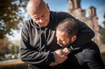 Two men quarrel and fight. Two thugs are fighting