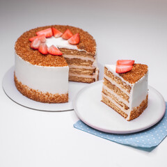 homemade honey cake decorated with strawberry slices