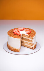 homemade honey cake decorated with strawberry slices