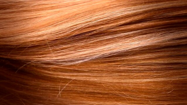 Hair. Beautiful healthy long smooth flowing brown coloring hair close-up texture. Dyed straight hair background, coloring, extensions, cure, treatment concept. Haircare. Slow motion 4K
