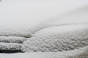 Snow covered car. Fresh snow on car in cold winter morning. Concept of driving in winter time with snow on road. Winter season. Copy space.