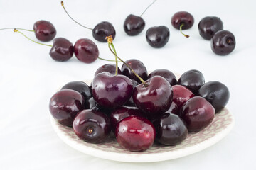 Naklejka na ściany i meble Fresh cherries on a white background