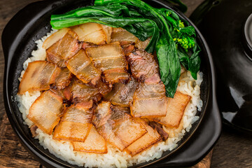 Cantonese style cooking of claypot rice with waxed meats