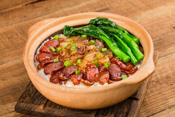 Cantonese style cooking of claypot rice with waxed meats