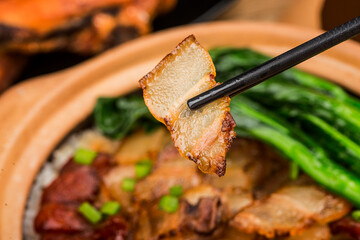 Cantonese style cooking of claypot rice with waxed meats