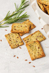 Homemade diet cookies with herbs, flax seeds and spices  on  light table. Crunchy rosemary crackers top view, close up plan