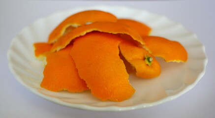Orange peel on a white saucer
