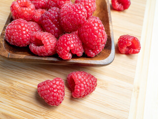 Raspberries in a wooden bowl.