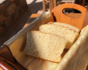 Homemade bread in a wooden box in one of the taverns in the mountains on the island of Crete in Greece - 484890455