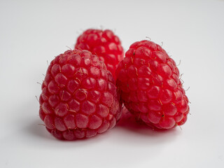 Raspberries on a white background