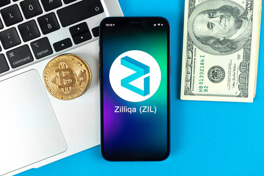 Zilliqa coin symbol. Trade with cryptocurrency, digital and virtual money, banking with mobile phone concept. Business workspace, table with laptop top view photo