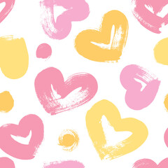 Seamless background with hearts in pink and yellow tones. Expressive dry brushes.
