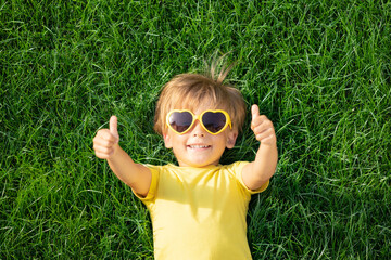 Happy child playing outdoor in spring park