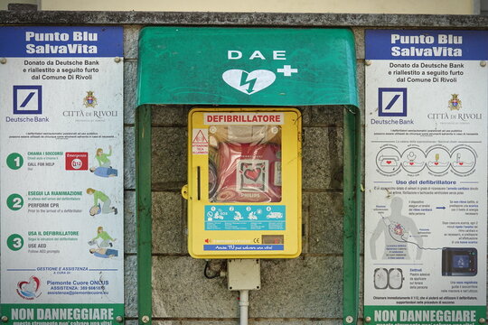 Emergency Defibrillator attached to the wall in the street. Rivoli, Italy - April 2020