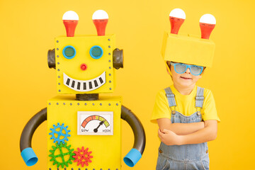 Happy child playing with robot