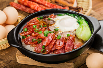 Cantonese style cooking of claypot rice with waxed meats