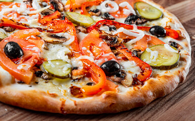 vegetarian pizza with Mozzarella cheese, grilled zucchini, mushrooms, red onion, pepper and olive. Italian pizza on wooden table background