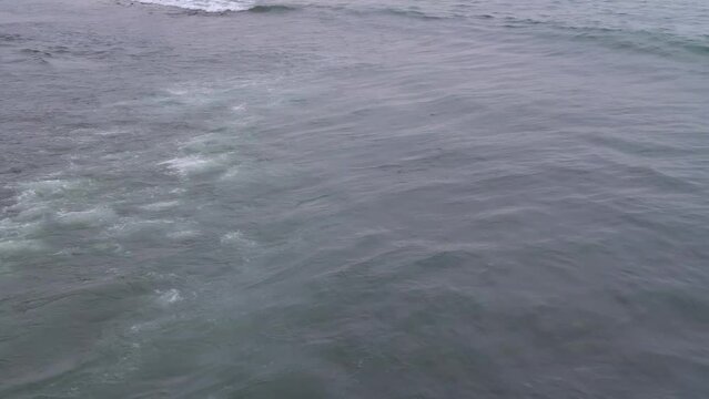 The waves are on the sea surface. Top view. Sea breeze. A wave in the ocean.