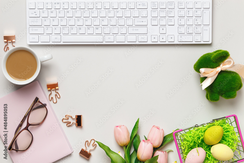 Poster desktop. glasses coffee cups keyboard notepad on a table with easter decorations. top view flat lay 