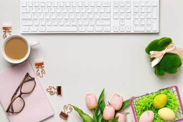 Desktop. Glasses coffee cups keyboard notepad on a table with easter decorations. Top view flat lay copy space