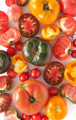 Composition of red, green and yellow tomatoes, top view.  Texture of food, cut of tomato close-up.