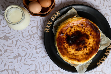 Creamy cheesecake with eggs and milk on white background