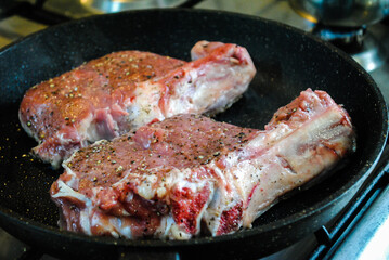 Beef meat is fried in a pan.