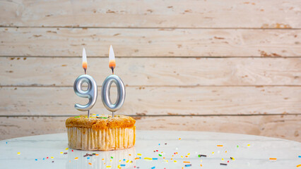 Happy 90th birthday greetings from silver numbers on white boards background copy space. Beautiful...
