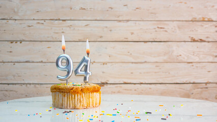 94 year happy birthday greetings from silver numbers on white boards background copy space....