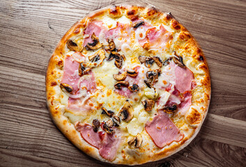 pizza with Mozzarella cheese, ham, mushrooms, onion. Italian pizza on wooden table background