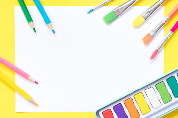 Pencils, brushes and paints on paper