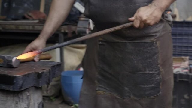 Blacksmith forged iron smith anvil hammer man manually forging the molten metal.