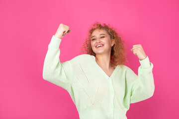 Happy young girl raises her fist up in delight! Successful victory gestures.