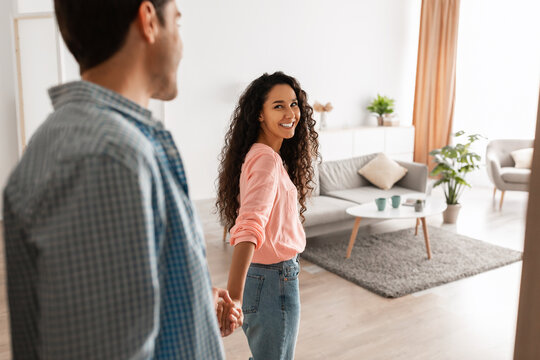 Happy lady inviting gyt to enter home