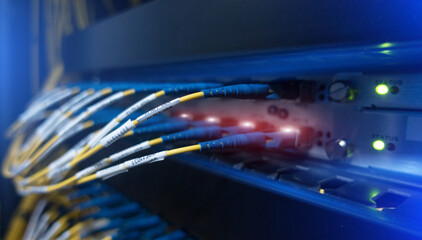 Close up fiber optic and hub in datacenter.