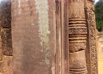 Ancient Khmer inscriptions carved on the walls of Angkor Wat ruins.