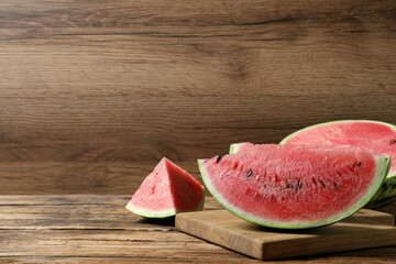 Slices of tasty ripe watermelon on wooden table, space for text