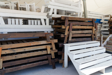 wooden sun loungers piled together after the beach season