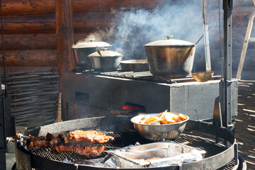 mobile open-air kitchen, food is cooked and steamed in pots and cauldrons