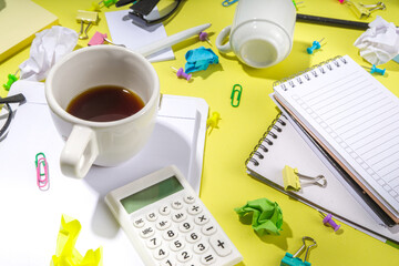 Brainstorming office table background. Office work table with notepads, pens, pencils, crumpled colorful paper, office supplies. Creative business team brainstorming concept flatlay yellow background 