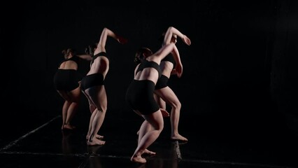 rehearsal in dance class, four young ballerinas is training modern choreography