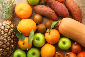 Various healthy fruit and vegetable on wooden background. Top view.