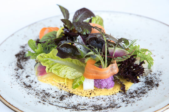 Colorful gourmet salad with mixed greens, carrot, purple cauliflower