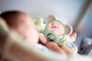 4 month old baby looking at himself in the mirror.