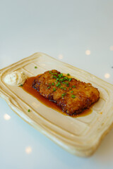 Japanese Food Style : Homemade fired  Chicken Teriyaki  put on the white platel and place on table.