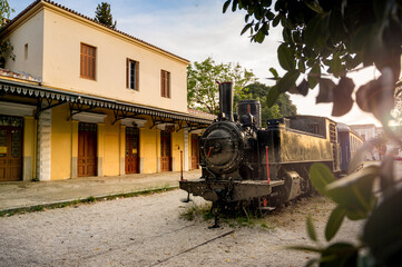 historic steam locomotive next to old station building - Nafplio, Peloponnese, Greece