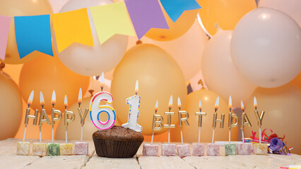 Happy birthday greetings for 61 years old from gold letters of candles burning against the...